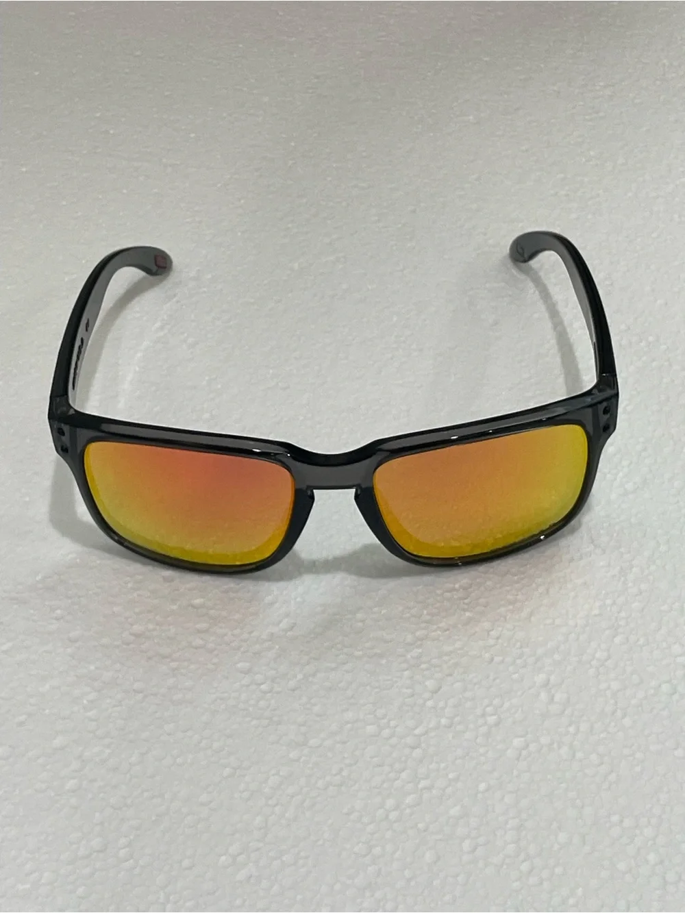 Oakley Translucent Black Frame Sunglasses with Yellow Mirrored Lenses